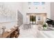 Bright living room featuring a high ceiling, herringbone floors, piano, modern furniture, and plenty of natural light at 5546 Drexel Rd, Land O Lakes, FL 34638