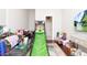 Eclectic living room features a sports game, television and rug at 5546 Drexel Rd, Land O Lakes, FL 34638