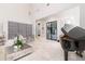 Elegant living room boasting high ceilings, herringbone floors, a piano, and lots of natural light at 5546 Drexel Rd, Land O Lakes, FL 34638