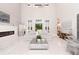 Bright living room with high ceilings, modern fireplace, elegant chandelier, and access to the pool area at 5546 Drexel Rd, Land O Lakes, FL 34638