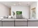 Open-concept living room with contemporary furnishings and a view of the custom wine room at 5546 Drexel Rd, Land O Lakes, FL 34638