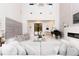 Bright and modern living room with a piano, fireplace, high ceilings, and sleek finishes at 5546 Drexel Rd, Land O Lakes, FL 34638