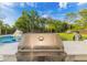 Outdoor kitchen with KitchenAid stainless steel grill and large backyard at 5546 Drexel Rd, Land O Lakes, FL 34638