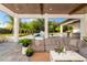 Relaxing outdoor living area featuring a cozy seating arrangement and view of the lush backyard at 5546 Drexel Rd, Land O Lakes, FL 34638