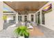 Inviting covered patio with comfortable seating, ceiling fan, and a large screen TV for relaxation at 5546 Drexel Rd, Land O Lakes, FL 34638
