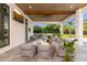 Stylish covered patio with comfortable seating, a ceiling fan, and a view of the green backyard at 5546 Drexel Rd, Land O Lakes, FL 34638