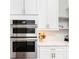 Modern kitchen appliances featuring built-in stainless steel ovens and white cabinets at 5546 Drexel Rd, Land O Lakes, FL 34638