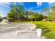Backyard area with an in-ground pool, and white lounge chairs on the patio at 5546 Drexel Rd, Land O Lakes, FL 34638