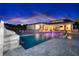 Stunning backyard with a luxurious pool, spa, and ample seating for outdoor entertaining at dusk at 5546 Drexel Rd, Land O Lakes, FL 34638