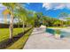 Swimming pool with tropical landscaping, an in-ground pool, and playground at 5546 Drexel Rd, Land O Lakes, FL 34638