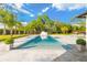 Swimming pool with in-ground spa, tropical landscaping, and outdoor kitchen at 5546 Drexel Rd, Land O Lakes, FL 34638