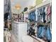 This walk-in closet has a central island for folding, shelves for shoes, and rods for hanging clothes at 5546 Drexel Rd, Land O Lakes, FL 34638