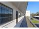 A balcony view of the building exterior with neutral tones and covered parking at 5969 Terrace Park N Dr # 203, St Petersburg, FL 33709