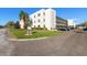 Corner view of the building exterior featuring well-maintained landscaping and parking area at 5969 Terrace Park N Dr # 203, St Petersburg, FL 33709