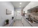 Efficient kitchen with white cabinetry and stainless steel sink at 5969 Terrace Park N Dr # 203, St Petersburg, FL 33709
