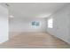 Neutral living room featuring light walls, wood floors, and adjacent kitchen tile floors at 5969 Terrace Park N Dr # 203, St Petersburg, FL 33709
