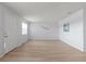 A view of the living room featuring wood flooring, neutral walls, and bright lighting at 5969 Terrace Park N Dr # 203, St Petersburg, FL 33709