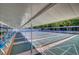 Community shuffleboard court featuring multiple lanes, shaded shelter, and comfortable seating for players and spectators at 5969 Terrace Park N Dr # 203, St Petersburg, FL 33709