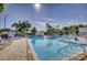 Large community swimming pool with clear blue water, ample lounge chairs, and lush landscaping, perfect for relaxation at 5969 Terrace Park N Dr # 203, St Petersburg, FL 33709