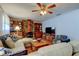 Spacious living room featuring a unique stone fireplace, hardwood flooring, and comfortable seating arrangements at 6435 43Rd N Ave, Kenneth City, FL 33709