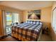 Bright bedroom with a large bed, sliding glass door, and views of the water and a serene atmosphere at 7138 E Bank Dr # 7138, Tampa, FL 33617