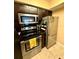 Fully equipped kitchen featuring stainless steel appliances, dark cabinets, and an efficient layout at 7138 E Bank Dr # 7138, Tampa, FL 33617