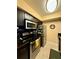 Modern kitchen featuring sleek black cabinets, stainless steel appliances, and granite countertops at 7138 E Bank Dr # 7138, Tampa, FL 33617