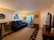 Warm living room with a decorative rug, a comfortable recliner sofa, and a serene window view at 7138 E Bank Dr # 7138, Tampa, FL 33617