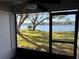 Screened in porch with lovely view of the water and landscape outside the windows at 7138 E Bank Dr # 7138, Tampa, FL 33617