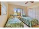 Bedroom furnished with twin beds, side table and lamps at 7564 Bayshore Dr # 207, Treasure Island, FL 33706
