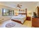Bedroom with a large window, ceiling fan, tiled floor, and a comfortable king size bed at 7564 Bayshore Dr # 207, Treasure Island, FL 33706