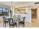 Charming dining area with seating for six, adjacent to a bright kitchen with modern appliances at 7564 Bayshore Dr # 207, Treasure Island, FL 33706
