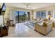 Inviting living room with comfortable seating, a large balcony door, and bright, airy ambiance at 7564 Bayshore Dr # 207, Treasure Island, FL 33706