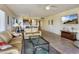 Spacious living area showcasing comfortable furniture, a TV, and an adjacent dining space with a view at 7564 Bayshore Dr # 207, Treasure Island, FL 33706