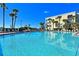 Large community pool with lounge chairs and ocean view at 7564 Bayshore Dr # 207, Treasure Island, FL 33706