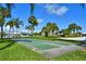 Outdoor shuffleboard courts surrounded by landscaping and palm trees create a relaxing atmosphere at 7564 Bayshore Dr # 207, Treasure Island, FL 33706
