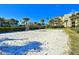 Outdoor sand volleyball court with buildings, landscaping, and palm trees surrounding at 7564 Bayshore Dr # 207, Treasure Island, FL 33706