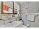 Bright bathroom with brick-patterned wallpaper and a modern vanity at 8490 7Th N Ln, St Petersburg, FL 33702