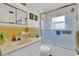 Clean bathroom featuring a shower with glass door, vanity and decorative mirror at 8490 7Th N Ln, St Petersburg, FL 33702