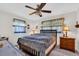 Comfortable bedroom with a ceiling fan and coordinating curtains at 8490 7Th N Ln, St Petersburg, FL 33702