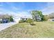 Charming single-story home with attached garage and well-maintained front lawn under a bright blue sky at 8490 7Th N Ln, St Petersburg, FL 33702