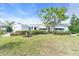 Charming single-story home with a well-manicured lawn and mature landscaping at 8490 7Th N Ln, St Petersburg, FL 33702