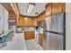 Functional kitchen with stainless steel appliances and wood cabinetry at 8490 7Th N Ln, St Petersburg, FL 33702