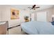 Bedroom with ceiling fan, neutral walls, closet, and light blue bedspread at 927 Lake Dr, Dunedin, FL 34698