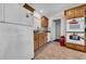 Galley kitchen features tile floors, wood cabinets, and white appliances at 927 Lake Dr, Dunedin, FL 34698