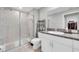 Bathroom featuring a tile shower, granite countertops, and modern vanity at 9623 Mulberry Marsh Ln, Sun City Center, FL 33573