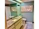Stylish bathroom with a granite vanity, soft blue walls, and coastal-themed artwork at 1020 Bowsprit Ln # X, Holiday, FL 34691