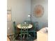 Cozy dining area with a round table, four chairs, and stylish wall art at 1020 Bowsprit Ln # X, Holiday, FL 34691