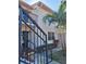 Charming condominium exterior featuring well-maintained landscaping and inviting staircase leading to the entrance at 1020 Bowsprit Ln # X, Holiday, FL 34691