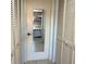 Hallway featuring a mirrored door, with white paneled doors on either side at 1020 Bowsprit Ln # X, Holiday, FL 34691